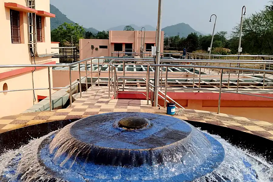 Cascade aerator in operation at water treatment plant with filter house